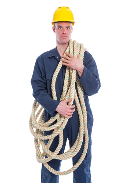 Worker in coverall and yellow helmet with large thick rope — Stock Photo, Image