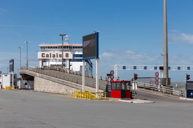 Ferry to England moored at harbor gate in Calais, France clipart