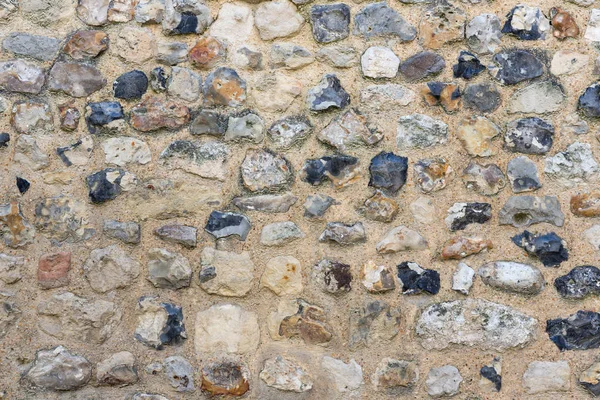 Antecedentes ladrillo viejo con piedras de diferentes colores —  Fotos de Stock