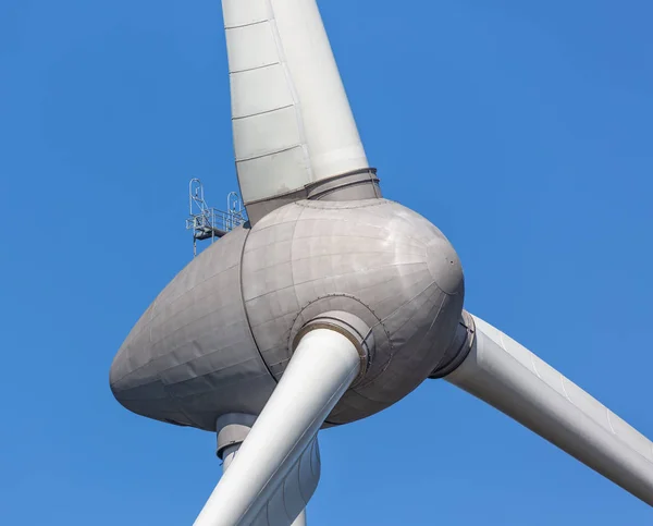 Primo piano di una grande turbina eolica contro un cielo blu — Foto Stock