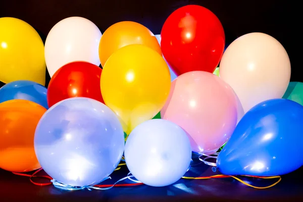 Palloncini colorati illuminati con LED sullo sfondo scuro — Foto Stock