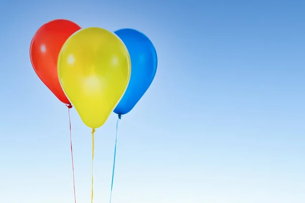 Colorful balloons for birthday and celebrations isolated at blue sky