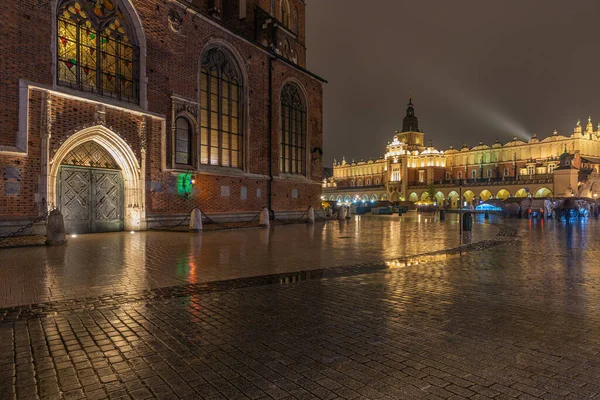 Lluvioso mercado vista por la noche plaza polaca Cracovia y Sukiennice pasaje — Foto de Stock