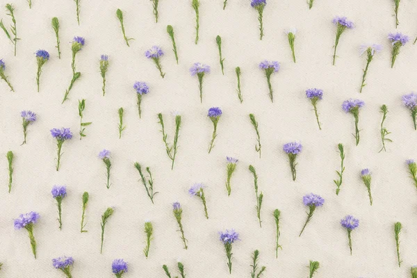 Purple cutter flowers pattern on white muslin fabric