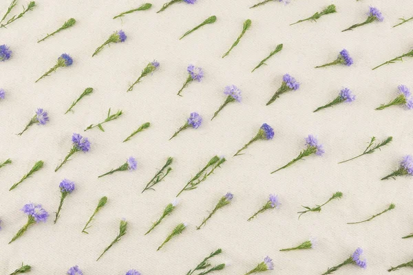 Purple cutter flowers pattern on white muslin fabric