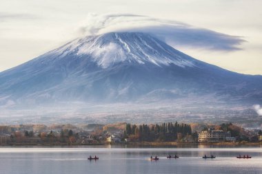 Fuji Mountain with Lenticular Cloud on Top and Tourist Boats at Kawaguchiko Lake, Japan