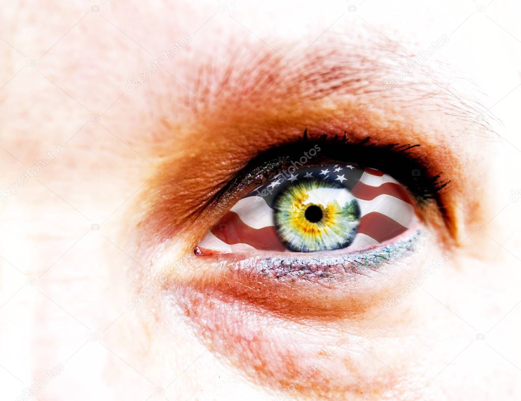 soft focus and close up of a green yellow woman eye isolated on a white background with usa flag in the iris