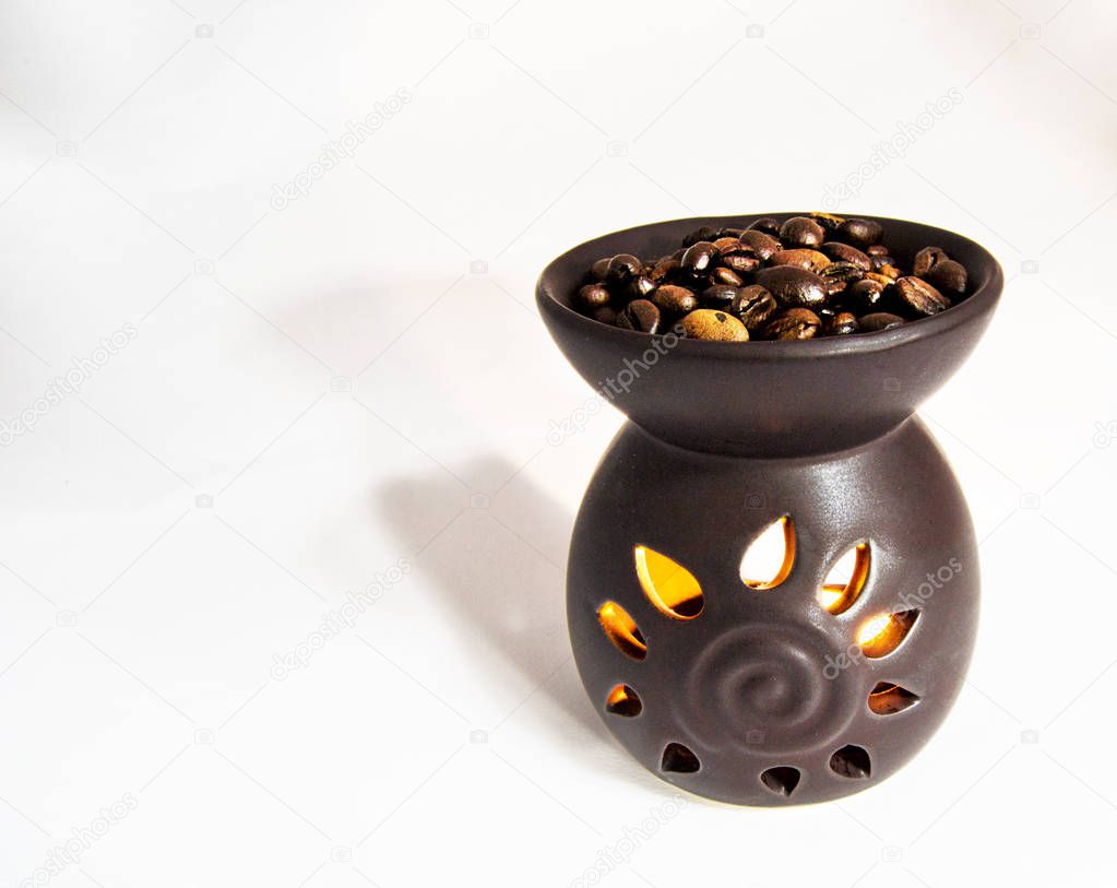 tea light candle heat oil perfume diffuser with coffee beans on the top. for aroma therapy concept