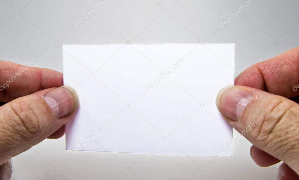 white empty card  with a man hand, for free text, on a gray background