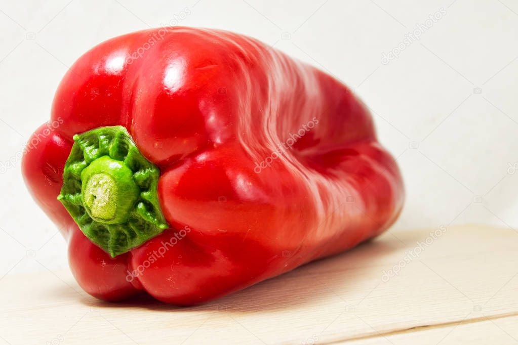 soft focus of a fresh red pepper on a white background - Capsicum, solanaceae