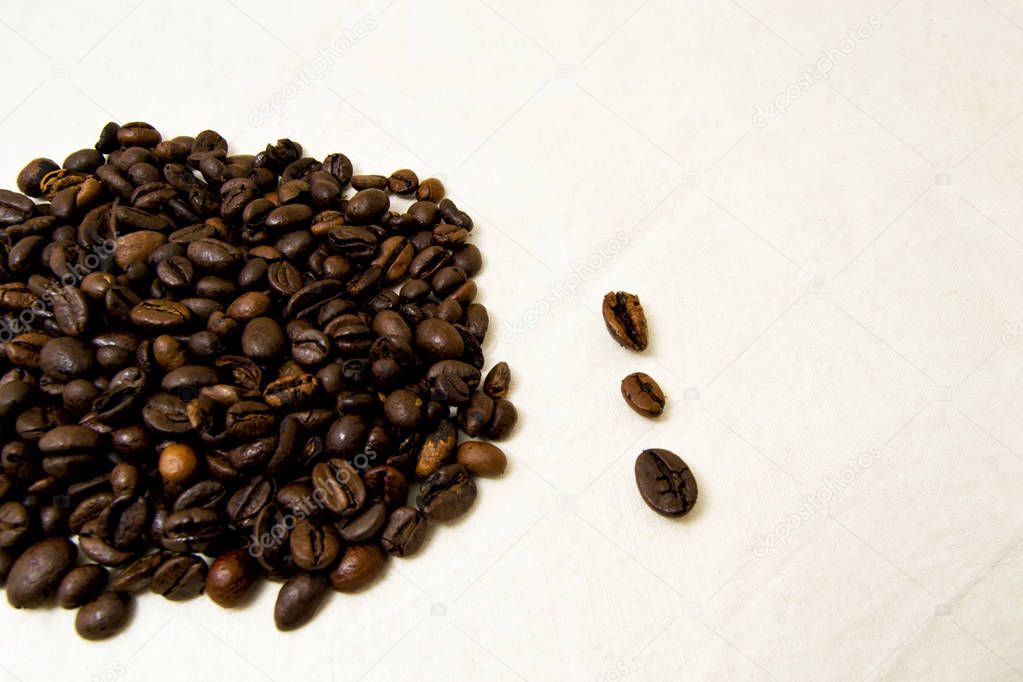 close up of roasted coffee beans with white background with space for text. to be used as background or texture