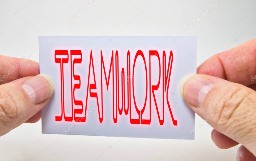 man hands holding a card with teamwork word on it, white background