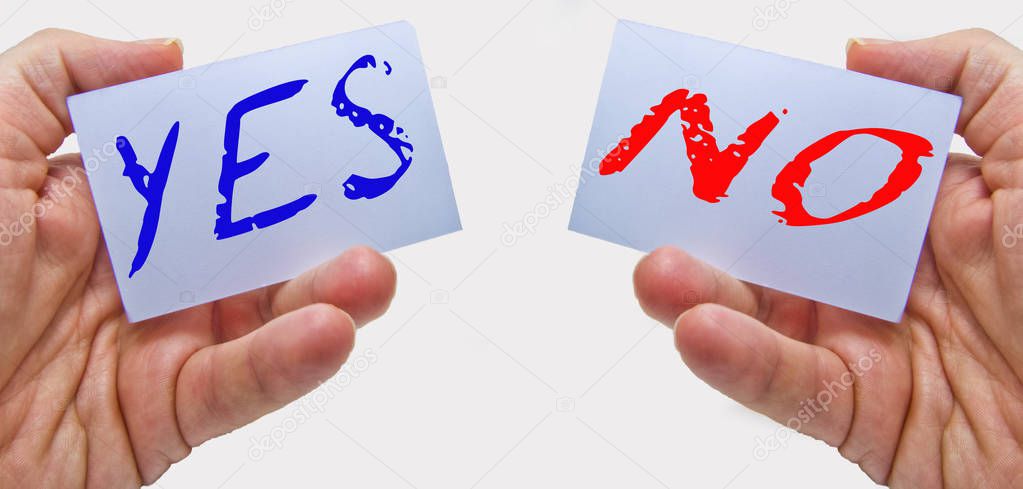 businessman showing yes (in blue color) and no (in red color) cards in his hands