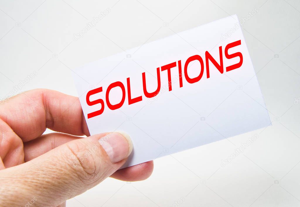 man hand holding a gray billboard with solution word written in it on a white background
