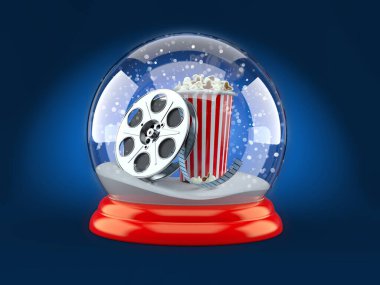 Film makaralı bir Noel küresi ve mavi arka Grou 'da patlamış mısır.