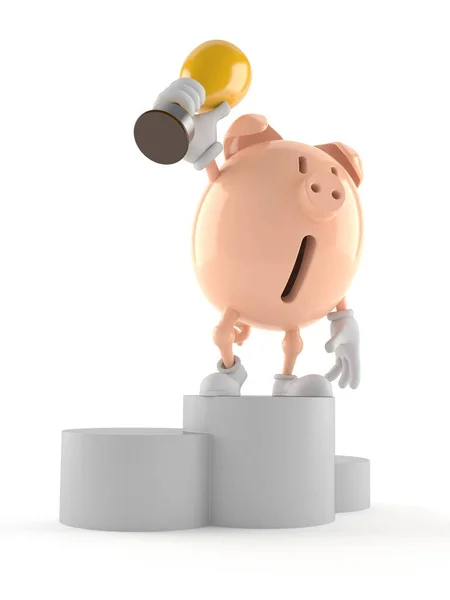 Piggy bank character on podium holding trophy — ストック写真