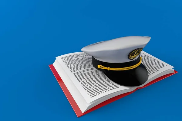 Kapitänsmütze auf offenem Buch — Stockfoto