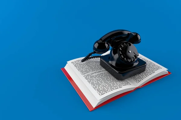 Telefoon op open boek — Stockfoto