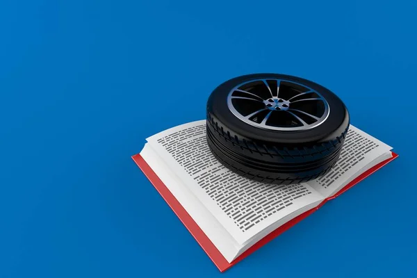 Neumático de coche en libro abierto —  Fotos de Stock