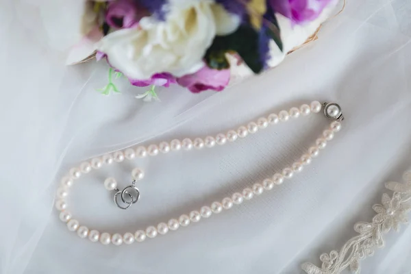 Wedding details. Wedding pearl jewelery close up photography