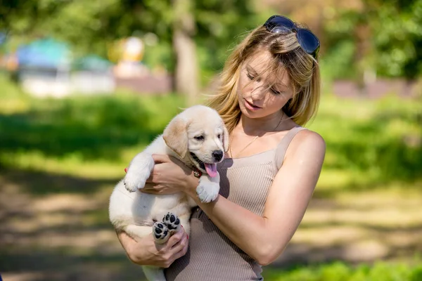 Girl with labrador puppy