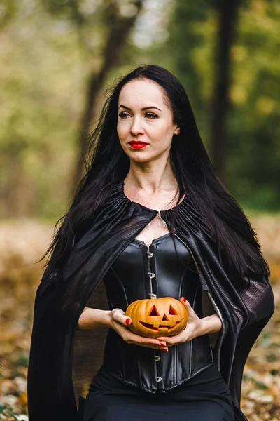 Young witch in the autumn forest — Stock Photo, Image