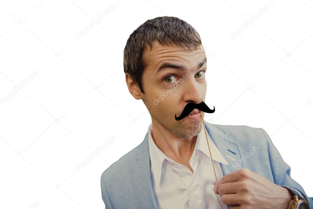 Portrait of an attractive young man dressed in a business style and fake mustache on an isolated white background