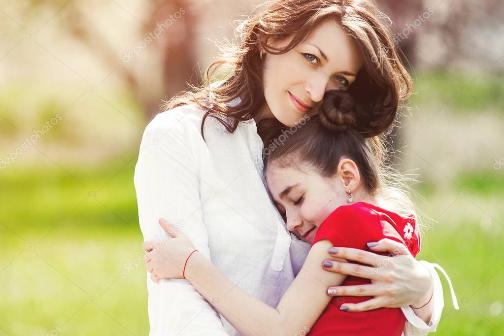 Happy mother and daughter with embracing, close up portrait.