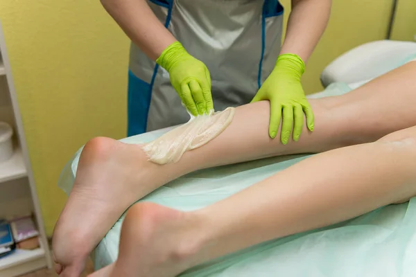 Sugaring Sugar waxing feet in the beauty salon.