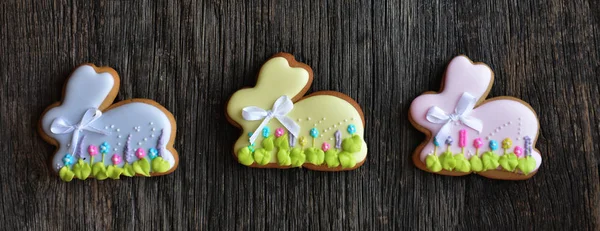 Easter holidays background - Easter bunnies cookies on a wooden background