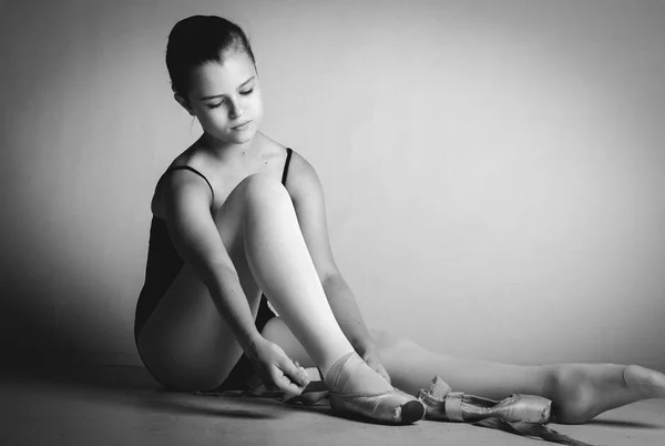Прекрасная балерина завязывает шнурки. — стоковое фото