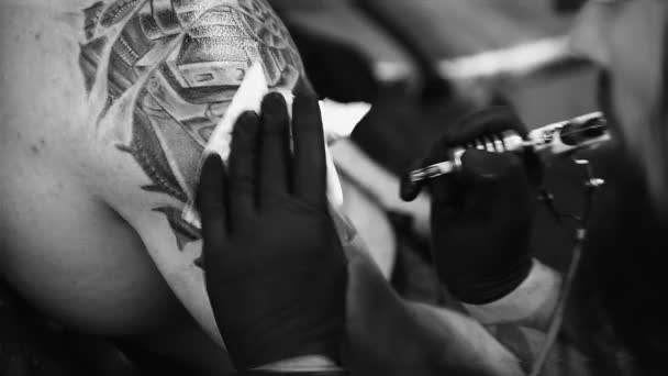 The process of creating a tattoo on the back of a man — Stock Video