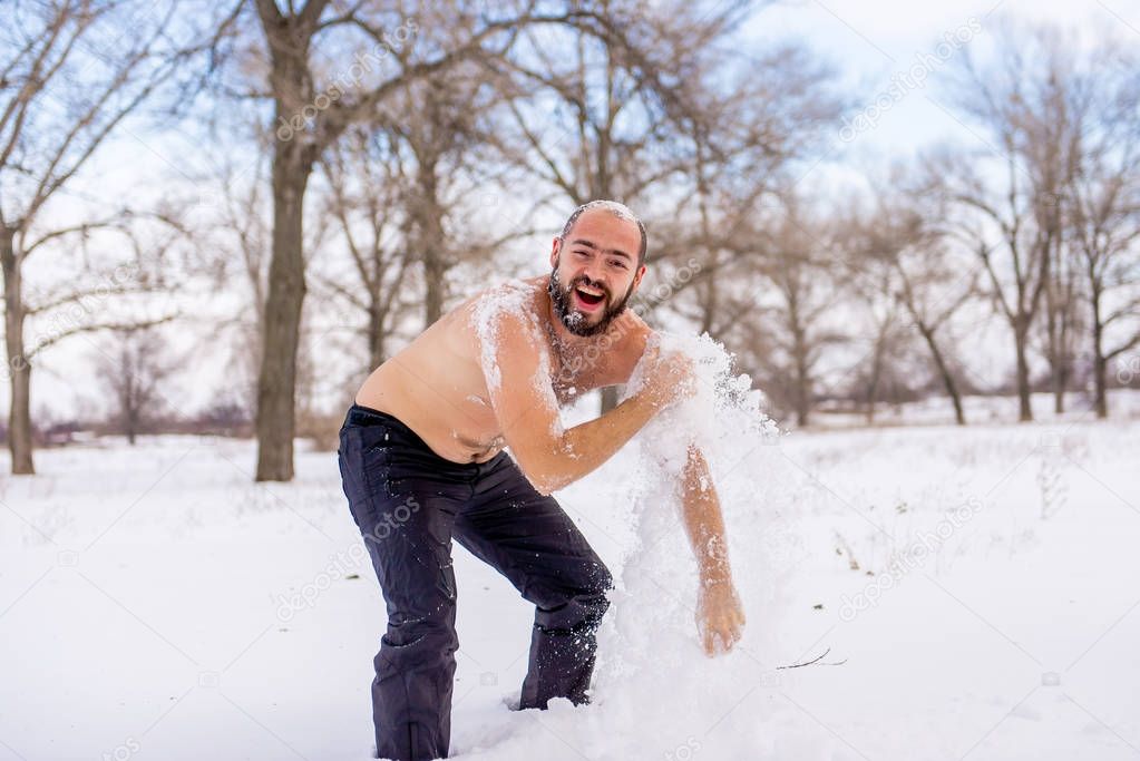 Young Man wiping snow in the winter, to promote health.
