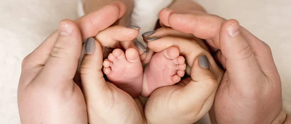 Mani dei genitori interessati bambino a piedi nudi — Foto Stock