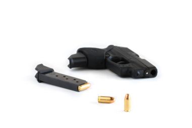 Handgun and magazine loaded with cartridges. clipart