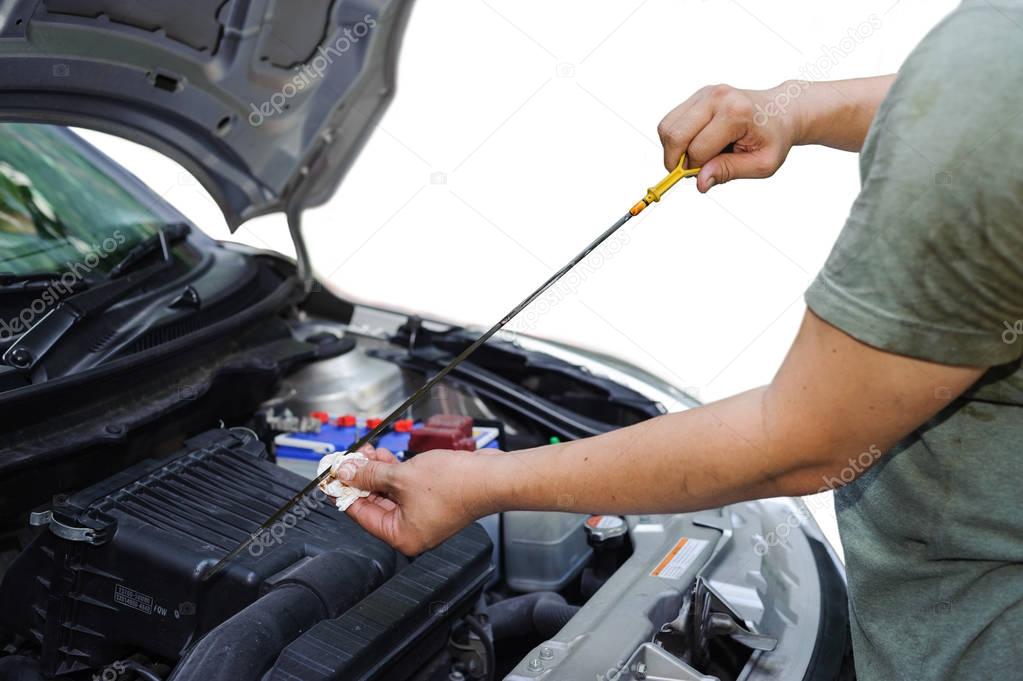 Car mechanic check oil level