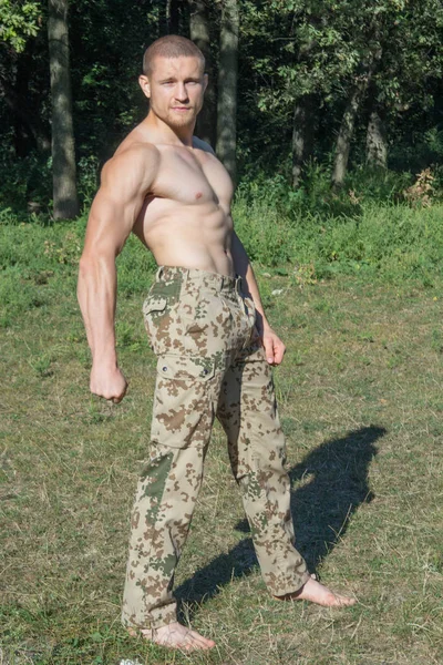 Sporty man in camouflage pants