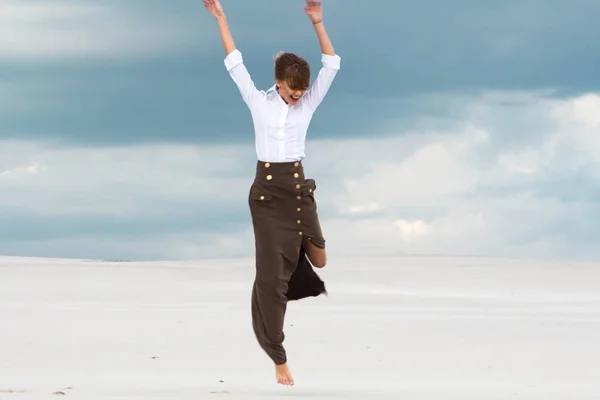 Woman jumping against the background of clouds — Stock Photo, Image