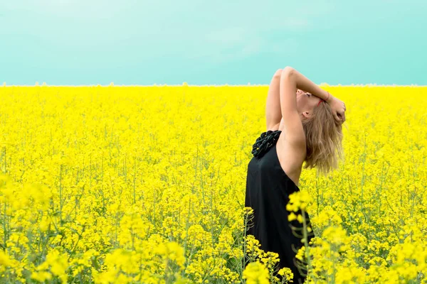 Mavi gökyüzüne karşı sarı çiçekler güzel kız — Stok fotoğraf