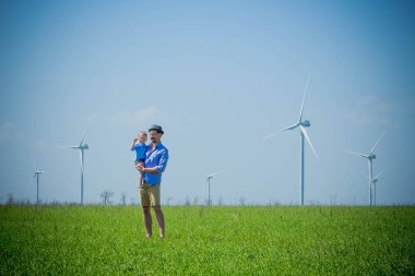 Baba oğlu bir çevre dostu yeşil alan kollarını tutar