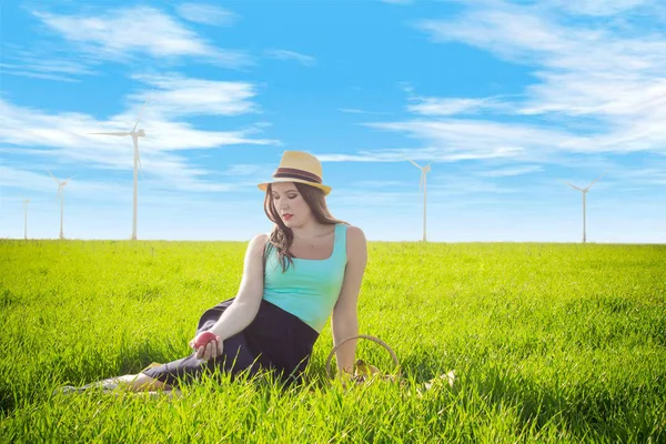 stock image Woman with fruit near wind generators