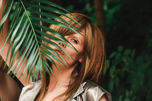 Bir kız bir fern şube görünüyor