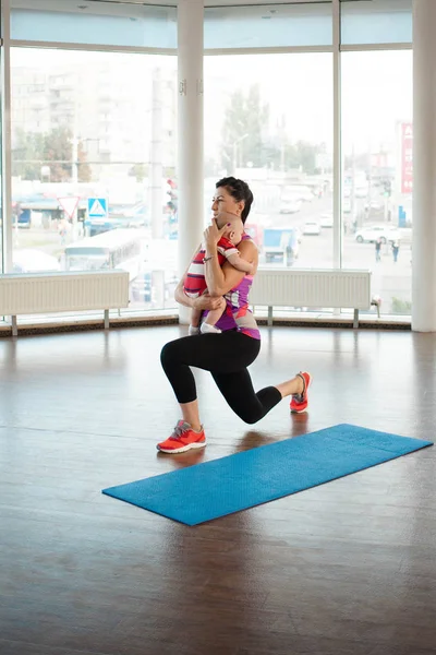 Mom goes in for sports with a child in a large, spacious gym