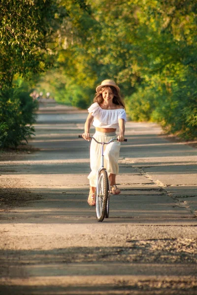 The girl is learning to ride a bicycle