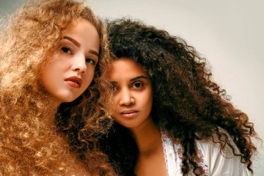 İki kıvırcık kız portresi. Afro ve sarışın
