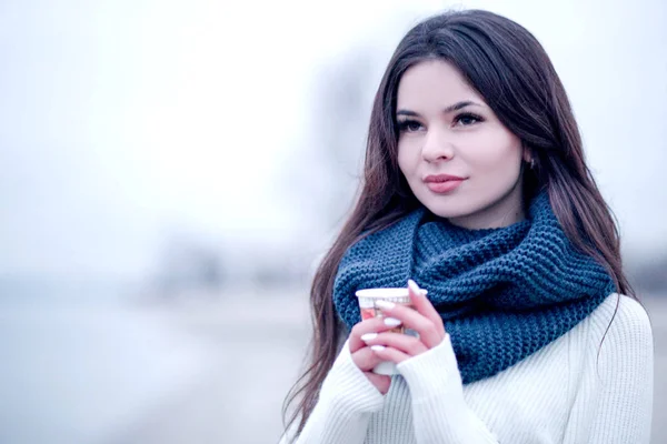 Beautiful young woman with a glass of coffee in winter — Stock Photo, Image