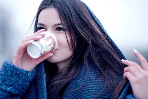 Portrait of a young woman in a coat with a collar that drinks coffee on the street — Stock Photo, Image