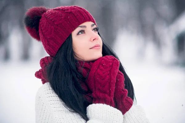 Une jeune femme douce, tendre et sensuelle dans un pull blanc et un chapeau lumineux, écharpe et mitaines — Photo