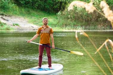 Bir yandan çarklı bir sup tahta üzerinde olan bir adam