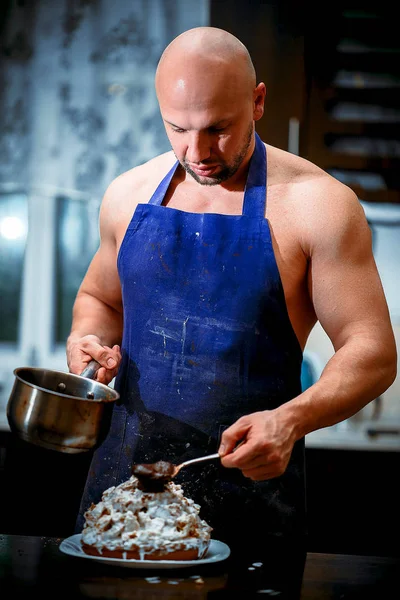 A young man is cooking in a large kitchen — Stock Photo, Image